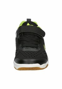 Black athletic shoe with mesh upper, neon green accents, adjustable strap, and white midsole. Features rubber sole for traction and flexibility.