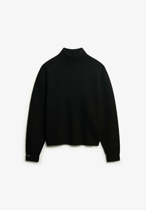 Zwarte coltrui van ribstof, met lange mouwen en een ontspannen pasvorm, voorzien van een subtiele merketiket op de manchetten.