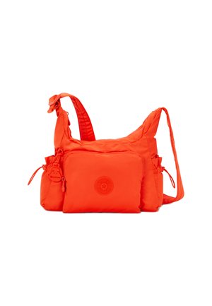Orange nylon shoulder bag with a textured surface, adjustable strap, front zip pocket, and a round logo accent. Includes a monkey charm.