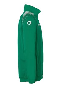 Green athletic jacket with a high collar, textured shoulder accents, logo on the left sleeve, and a smooth, fitted design.