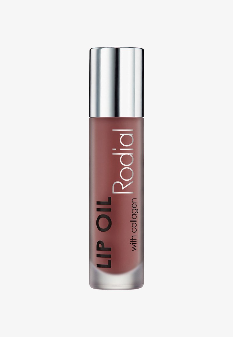 Lippenöl in einem gefrosteten Glasbehälter mit einem silbernen Metallverschluss. Mit schwarzem Text: "LIPPENÖL" und "Rodial" auf einem mauvefarbenen Hintergrund.