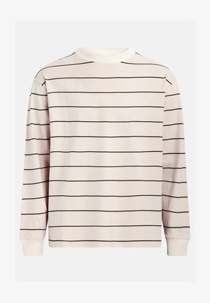 Hosszú ujjú pamut ing, krémszínű alap fekete vízszintes csíkokkal, kerek nyakkivágással és bordázott mandzsettával.