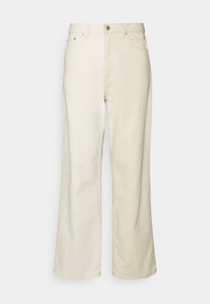 Licht beige wijde jeans gemaakt van denim. Beschikt over een klassiek vijf-pocket ontwerp, knoopsluiting en minimale stikdetails.