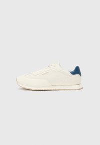 White athletic sneakers with a perforated texture, smooth leather, and a contrasting blue heel accent. Round toe and flat rubber sole.