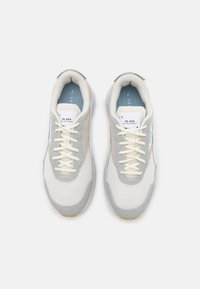 Scarpe sportive grigio chiaro con tomaia in rete e suede, lacci crema, suola in gomma e soletta blu, con un discreto dettaglio del logo.