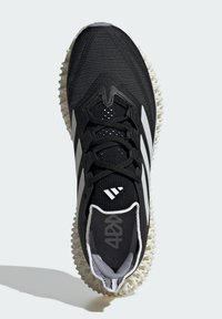 Black athletic shoe with textured fabric upper, featuring three white stripes, a padded tongue, and a distinctive white rubber outsole.
