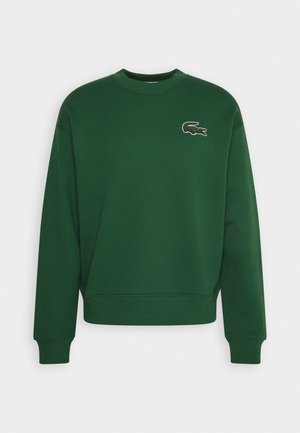 Dunkelgrünes Sweatshirt mit Rundhalsausschnitt, gerippten Bündchen und Saum, mit einem kleinen bestickten Krokodil-Logo auf der linken Brust.