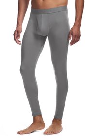 Graue Leggings aus einem glatten, dehnbaren Material mit einer eng anliegenden Passform. Verfügt über einen elastischen Bund mit Markendesign und ein elegantes, minimales Erscheinungsbild.