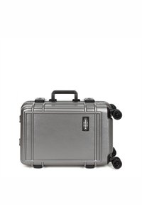 Metallic silver hard-shell suitcase with a textured surface, 4 wheels, and a top handle. Features a black logo and sturdy latches.