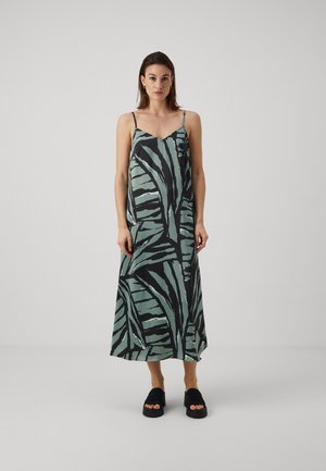Sleeveless midi dress in green and black with a leaf print, made of smooth fabric. Features thin straps and a loose-fitting design.