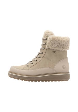 Beige lace-up ankle boots with a soft faux fur cuff, smooth and textured upper, and a thick rubber sole featuring a subtle logo.