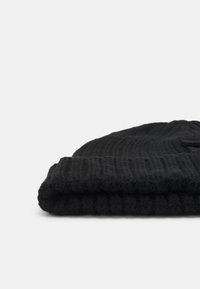 Black knit beanie, soft texture with ribbed pattern. Features a folded cuff, rounded top, and compact design suitable for warmth.