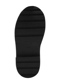 Suela de zapato de goma negra con surcos horizontales, punta redondeada y un patrón texturizado para mayor agarre. Marcada con "MNG" en el costado.