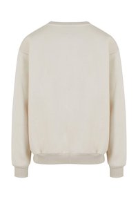 Tætsiddende sweatshirt i let beige. Har ribbede manchetter og kant, afslappet pasform og en glat tekstur uden synlige mønstre eller grafik.