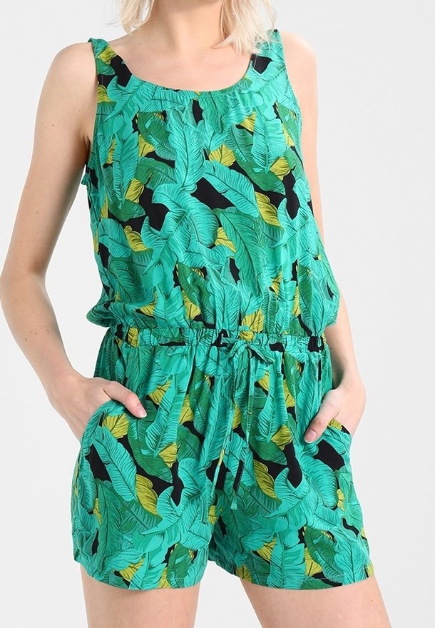 Grön jumpsuit med ett tropiskt bladmönster i gult och svart, med en rundad halsringning, ärmlös design och ett elastiskt midjeband.