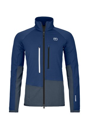 Blau-graue Jacke mit langen Ärmeln und hohem Kragen, vorne mit Reißverschluss, zwei vertikalen Reißverschlusstaschen auf der Brust und Logo auf der linken Seite.