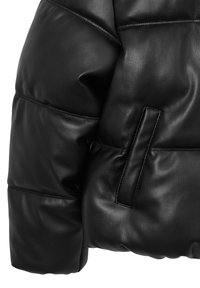 Veste en cuir noir, avec un design matelassé comprenant des sections rembourrées, une texture lisse et une poche insérée sur le côté gauche.