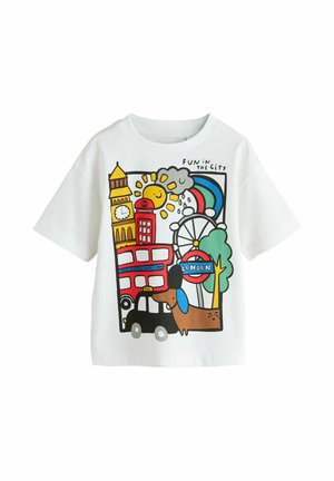 White t-shirt with colorful London-themed illustration including Big Ben, double-decker bus, black taxi, London Eye, rainbow, sun, cloud, and a dog.