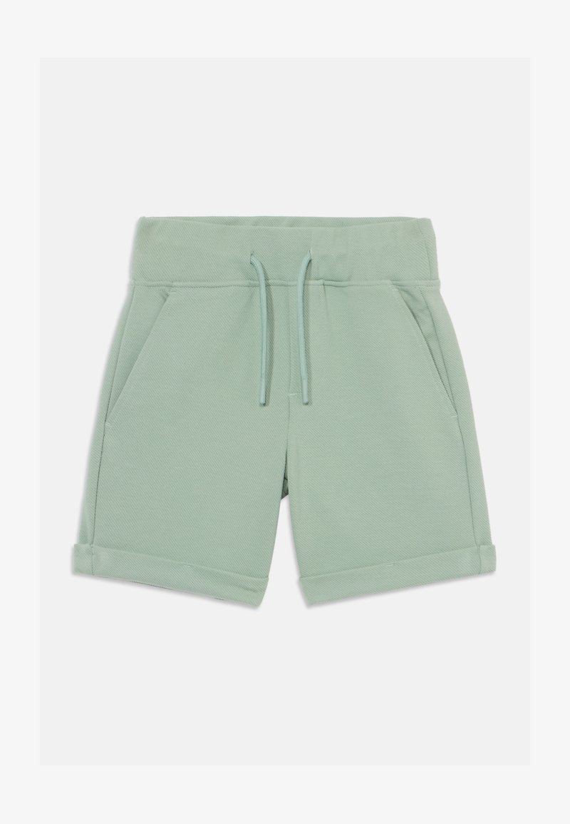 Shorts en coton vert clair avec taille élastique, cordon de serrage et deux poches latérales. Ourlets roulés et tissu texturé.