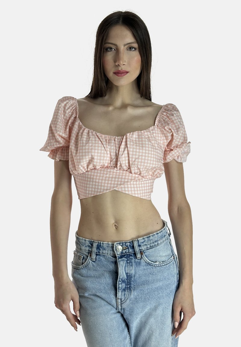 Top corto in gingham rosa con maniche a sbuffo e scollatura quadrata, abbinato a jeans in denim chiaro a vita alta. Texture liscia.
