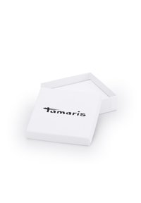 Weißer rechteckiger Karton mit einem abnehmbaren Deckel, der auf der Vorderseite ein auffälliges schwarzes Logo "tamaris" zeigt. Glatte Oberfläche und schlichtes Design.