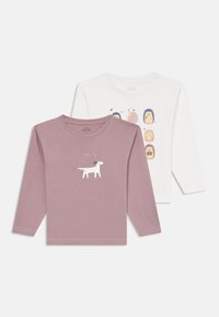 Divas garajumz kā štacijas: viens mauve krāsā ar suņa grafiku, otrs balts ar ezīšu ilustrācijām. Mīksts kokvilnas audums, vienkārši apaļi izgriezumi.