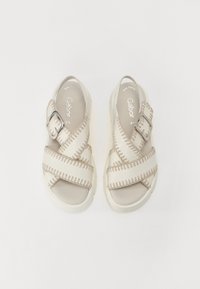 Beige sandaler med kryssende stropper, en teksturert finish, metallspenne og en polstret såle, med "Gabor" merkevare innvendig.