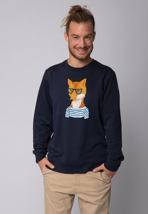 Navy blue sweatshirt featuring an embroidered fox wearing glasses and a striped shirt. Soft texture and classic fit. Adjustable hem.