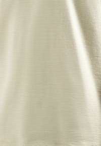 Lichtbeige top van een getextureerde stof, met subtiele horizontale ribbels. Glad afgeb worked met een zachte uitstraling en delicate naden.