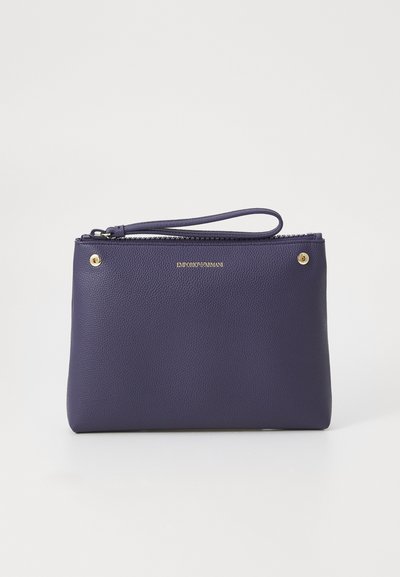 Deep purple clutch bag with a textured finish, zipper closure, and a wrist strap. Features a gold logo and decorative studs.