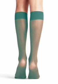 Knielange kousen in teal met een gladde, doorzichtige textuur, voorzien van een stevige tailleband. Verkrijgbaar in verschillende maten.