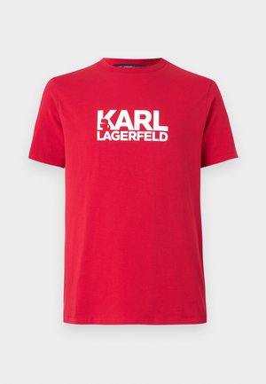 Rød bomullst-skjorte med kort erme og rund hals, med et stort hvitt logo-print av "KARL LAGERFELD" på forsiden.