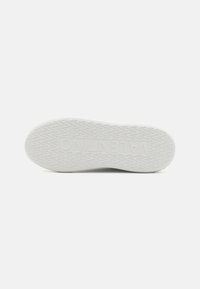White rubber shoe sole featuring textured geometric pattern and embossed branding "VALENTINO" near the heel. Flat and rounded design.