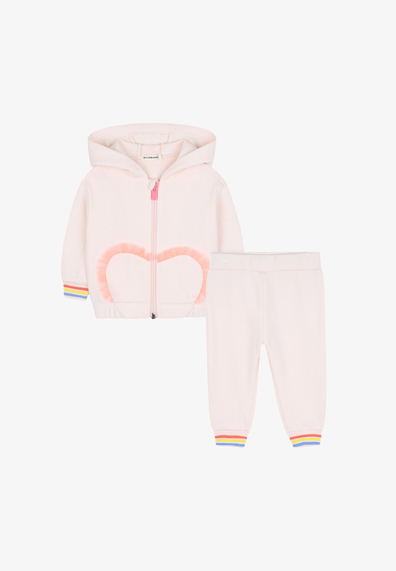 Felpa per bambini in morbido rosa con zip e dettaglio cuore in tulle, abbinata a pantaloni coordinati con polsini a righe multicolori.