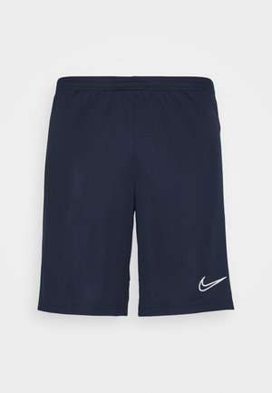 Tmavě modré sportovní šortky s elastickým pasem a bílým logem Nike swoosh na dolní části pravé nohy.