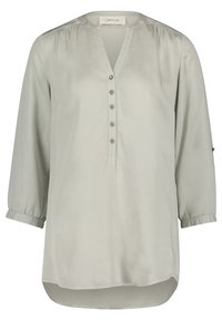 Blusa grigia chiaro a maniche lunghe in tessuto morbido; scollo a V con cinque bottoni, spacchi laterali e maniche con polsini.