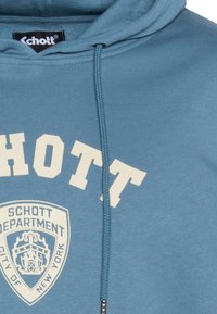 Sweat à capuche bleu en tissu texturé. Présente un grand logo "SCHOTT" clair et un design de badge au centre. Capuche avec cordon de serrage.