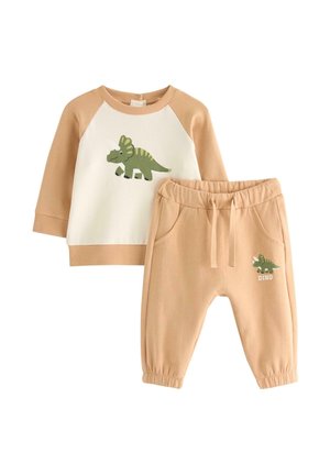 Beiges zweiteiliges Kleinkind-Set mit Dinosaurier-Grafik auf weiß-beigem Langarmshirt und passenden Hosen mit elastischem Bund und Taschen.