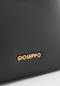 Črna usnjena torbica z teksturirano površino in zlatim logotipom "GIOSEPPO". Oblika je elegantna z minimalnimi detajli.