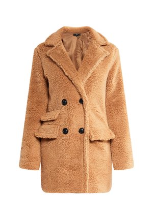 Bēšas krāsas, divrindīgs mākslīgā kažokādas mētelis ar ieliektām malām, sānu kabatām, melniem pogām un mīkstu, strukturētu audumu.