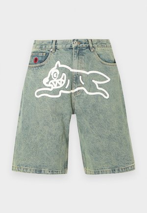 Denim shorts with a white cartoon dog graphic across the front and a small red embroidered patch near the pocket.