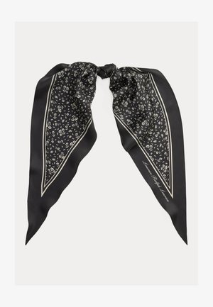 Pañuelo de seda negro con pequeño estampado floral blanco, borde blanco doble y delgado, y centro anudado.