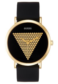 Montre noire avec un boîtier rond en or, présentant un motif de points dorés en forme de triangle sur un cadran noir. Le bracelet en silicone offre une durabilité.