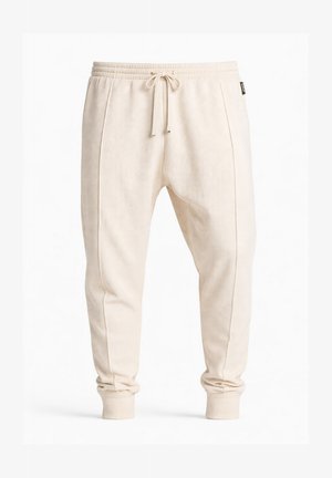 Pantalon de jogging beige en maille gaufrée avec taille élastique, cordon de serrage à l'avant, coutures latérales et poignets côtelés.