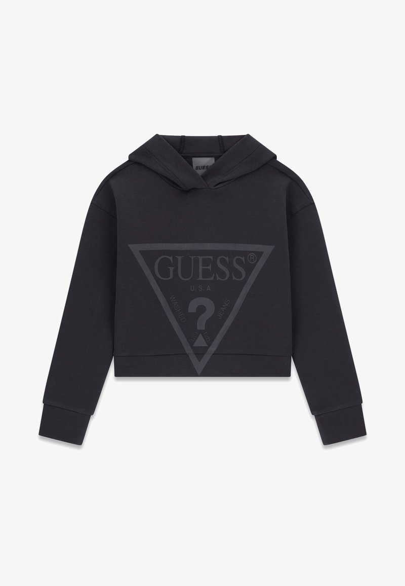 Must have lühikeste varrukatega must kapuutsiga sviiter, mille ees on suur tuhm Guess logo, mis sisaldab kolmnurka ja küsimärki.