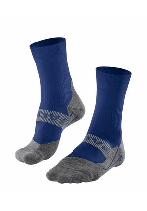 Calcetines azules y grises con parte superior acanalada, plantilla acolchada y detalles a rayas. Fabricados con material que absorbe la humedad para un mejor rendimiento.