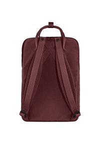 Burgundy backpack with cross-stitched straps, smooth texture, top handle, and adjustable padded shoulder straps. Simple, rectangular design.