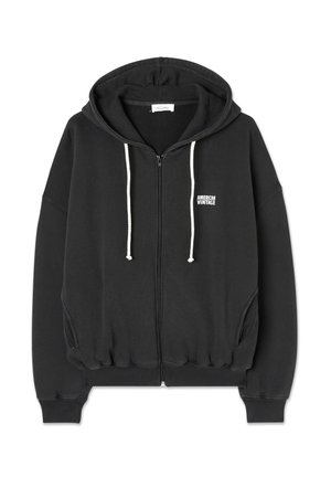 Zwarte sweatshirt met capuchon, ritsluiting, witte trekkoordjes en geribbelde manchetten. Bevat een klein "American Vintage" logo op de borst.