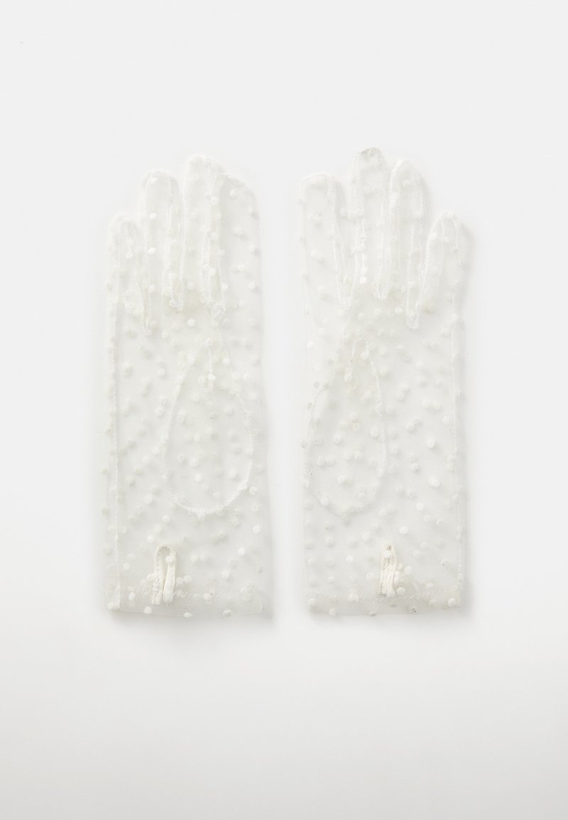 Läbipaistvad, täpilised kindad, mis on valmistatud õhukesest materjalist ja millel on tekstureeritud pind, elastsete avadega randmel, tagamaks hea sobivuse.