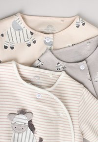 Three baby bodysuits with snap buttons, featuring zebra prints and light pastel stripes in beige, gray, and cream colors.
